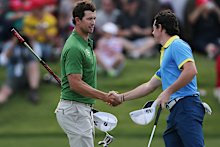 Rory McIlroy, right, of Northern Ireland shakes hands with Australia’s Adam Scott.