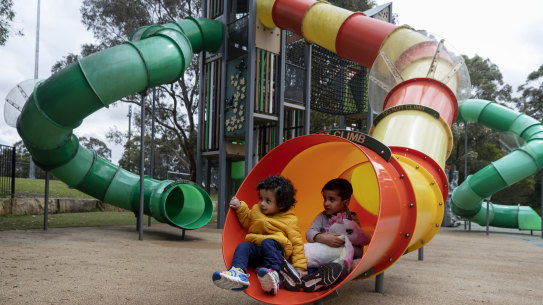 Dastagir and Maaz Mohammed  play on a tube slide at Strathfield Park.