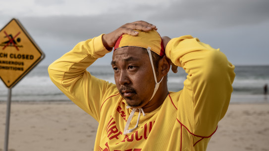 NEWS: Volunteer lifesaver Masaki Shibata at Tamarama beach. He is a linguist and researcher who has written a research paper showing many foreign students - and some domestic students too - don’t understand basic signs at the beach.