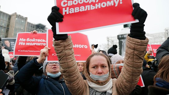 Women hold placards that read: “Freedom for Navalny!“.
