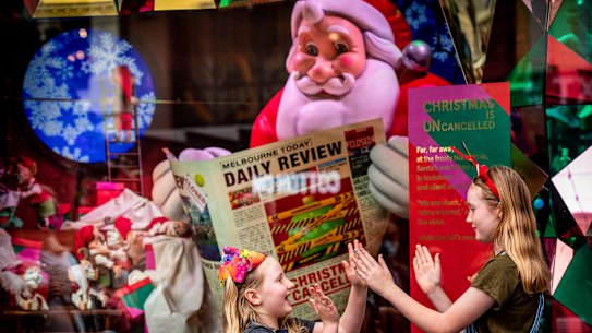  Santa catches up on the news in the Myer Christmas windows. 