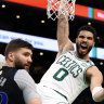 Jayson Tatum #0 of the Boston Celtics reacts as he dunks the ball against Maxi Kleber #42 of the Dallas Mavericks.