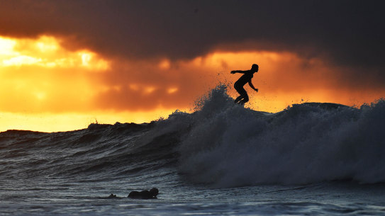 A surfer tackles the big waves at Bells Beach.