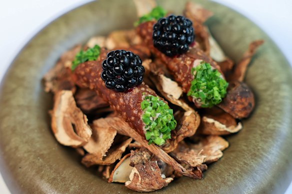 Duck liver parfait and porcini mushroom cannoli, each topped with a blackberry.