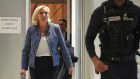 Marine Le Pen leaves the courtroom after a judge found her guilty in an embezzlement case.