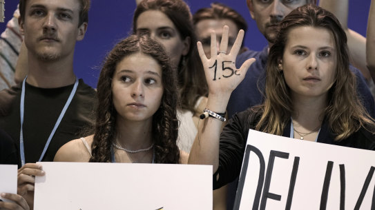 Climate activists from Germany encourage world leaders to maintain policies that limit warming to 1.5 degrees at the COP27 UN Climate Summit on Saturday.
