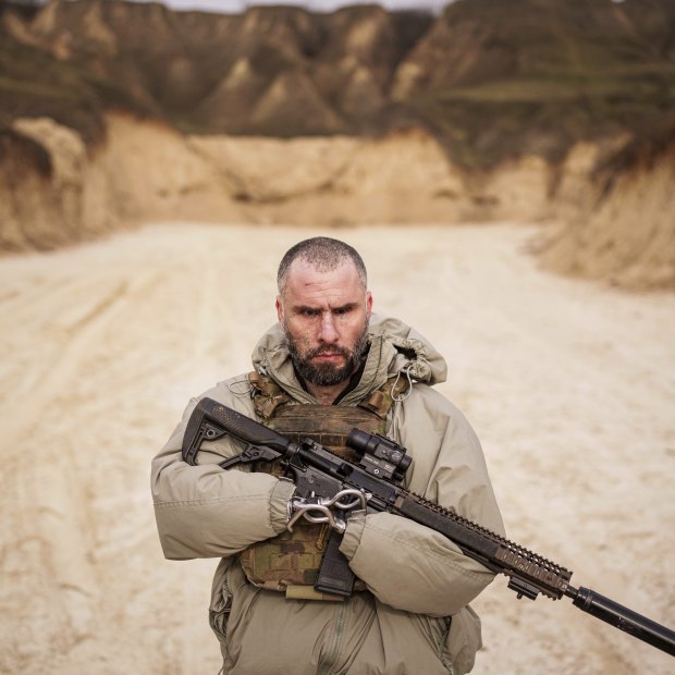 Andrii Rubliuk, a senior sergeant with a Ukrainian intelligence unit who lost both arms and a leg in combat, holds a rifle during military training near Kyiv.