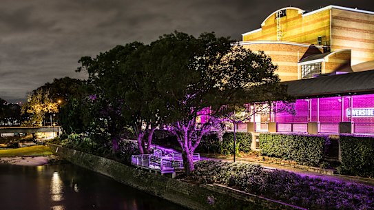 Riverside Theatre lit by night.