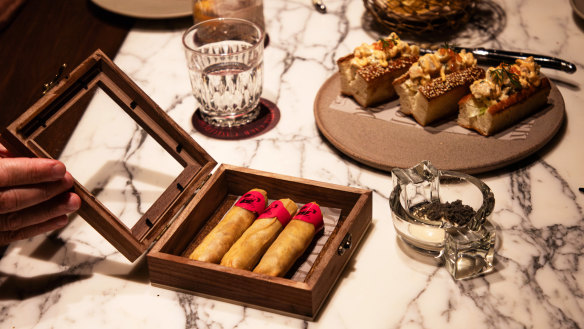 Duck-filled pastry cigars come with foil tips and are presented in a cigar box.