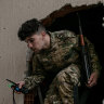 A fighter of the UN recognised Libyan government of national accord exits a building in Salah al-Din frontline in Tripoli last week.