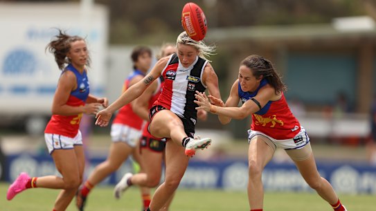 Tarni White gets a kick away for the Saints.