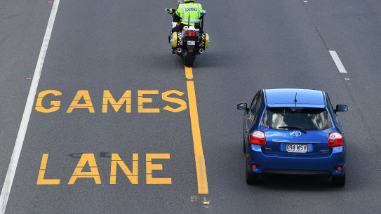 A police officer patrols near a designated Commonwealth Games Lane on the Gold Coast, Wednesday, March 28, 2018. Games Lanes will be activated over the weekend of 31 March for use by accredited vehicles travelling along the Games Route Network which links the Commonwealth Games Village at Parklands to key venues at Southport, Broadbeach and Carrara. (AAP Image/Dave Hunt) NO ARCHIVING . FOR BRISBANE TIMES USE.