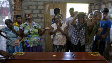 Relatives weep near the coffin with the remains of 12-year Sneha Savindi, who was a victim of Easter Sunday bombing at St Sebastian Church.