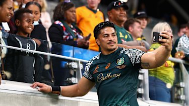 Pete Samu poses with fans for a photo after Australiaâ€™s 27-8 win over Argentina. 