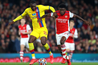 Christian Benteke and Thomas Partey battle for the ball.