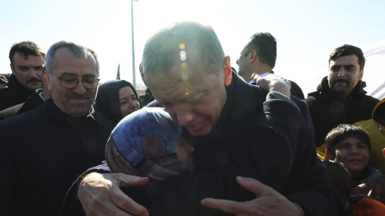 Turkish President Recep Tayyip Erdogan hugs a survivor in Kahramanmaras, a city devastated by last month’s earthquakes.