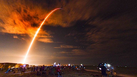 Crowds on the beach in Cape Canaveral, Florida watch the launch of the SpaceX Falcon 9 Crew Dragon on its Crew-1 mission carrying four astronauts, Sunday, November 15.