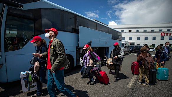 Employees of the Russian embassy in Prague and their families arrive to board a Russian government plane  at Vaclav Havel Airport in Prague, Czech Republic. 