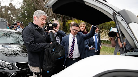 AFP officers arrived at Cameron Gill's  home at 7am and stayed for more than six hours, leaving with large plastic bags of evidence and several hard cases.