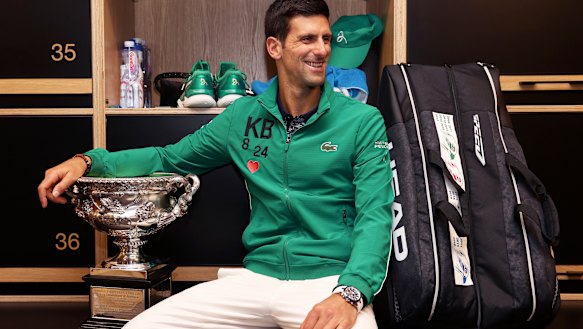 Djokovic with the Norman Brookes Cup in the locker room after his five-set victory over Dominic Thiem.