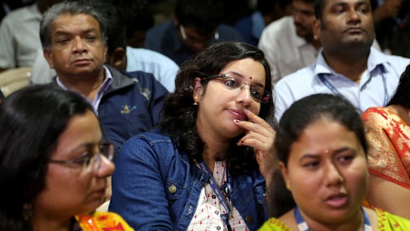 Indian Space Research Organisation (ISRO) employees react after the announcement.
