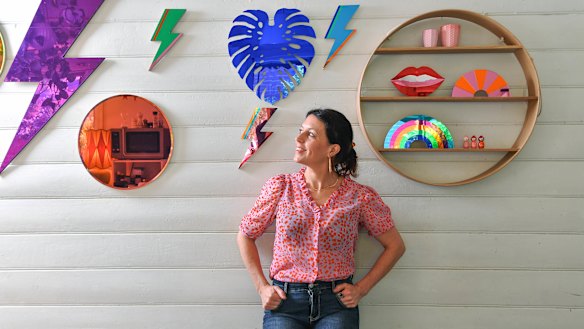 Miranda  Moreira, founder of Bride & Wolfe in her studio with her signature circular shelving and mirrors.
