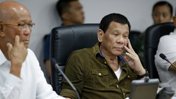 Philippine President Rodrigo Duterte, centre, and Defence Secretary Delfin Lorenzana, left, attend a command briefing on typhoon Mangkhut.