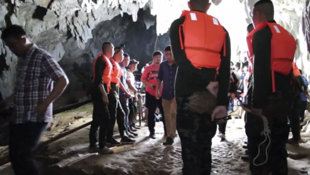 Rescue teams gather at the entrance of a deep cave where a group of boys went missing in Chang Rai, northern Thailand. 