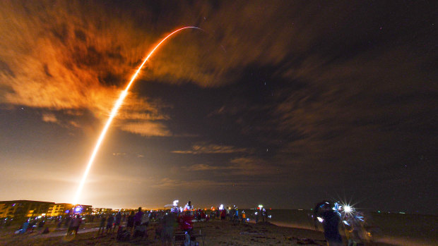 Crowds on the beach in Cape Canaveral, Florida watch the launch of the SpaceX Falcon 9 Crew Dragon on its Crew-1 mission carrying four astronauts, Sunday, November 15.