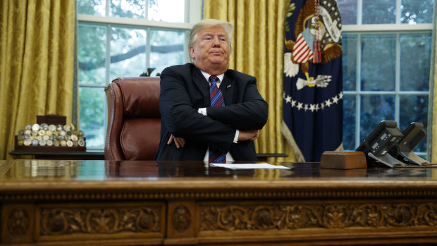 President Donald Trump crosses his arms after speaking with Mexican President Enrique Pena Nieto on the phone about a trade agreement.