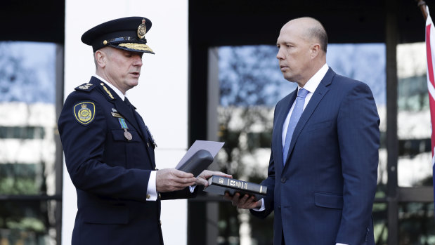 Home Affairs Minister Peter Dutton, right, swears in Australian Border Force commissioner Michael Outram  in May.