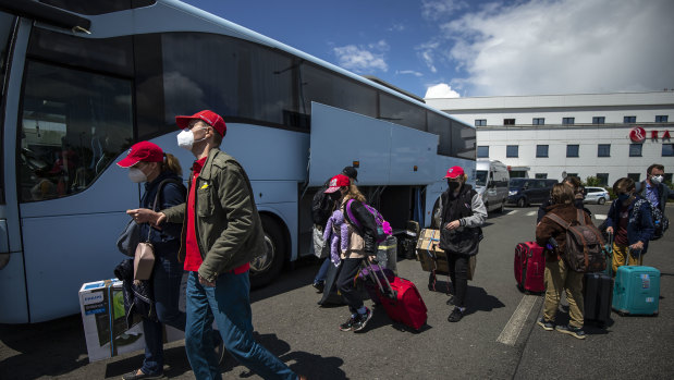 Employees of the Russian embassy in Prague and their families arrive to board a Russian government plane  at Vaclav Havel Airport in Prague, Czech Republic. 
