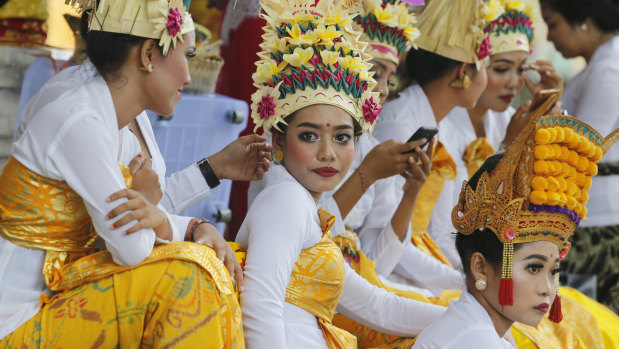 Balinese dancers wait to perform at a festival. Indonesia recently announced its first cases of COVID-19.