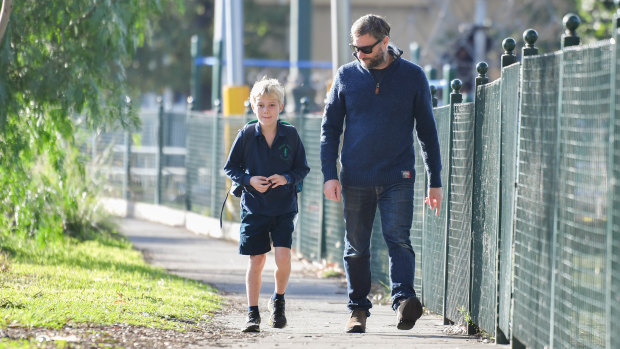 Grade three student Lachlan Hobbs with his father Tim Hobbs, returning to school at Albert Park Primary.