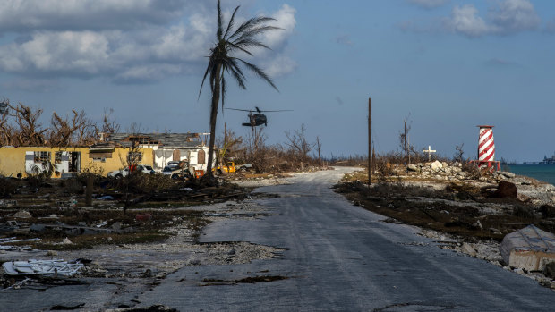 A helicopter flies over the village of High Rock, Grand Bahama, after delivering emergency supplies.