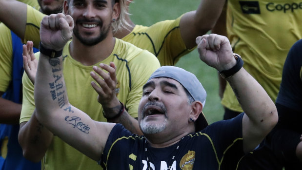 Rejoice: Diego Maradona sings with his team and fans during a training session with his new club Dorados.