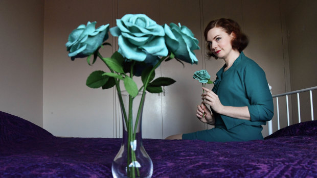 Hannah Poppins with some of her  handmade paper flowers, which she no longer describes as Tiffany blue. 