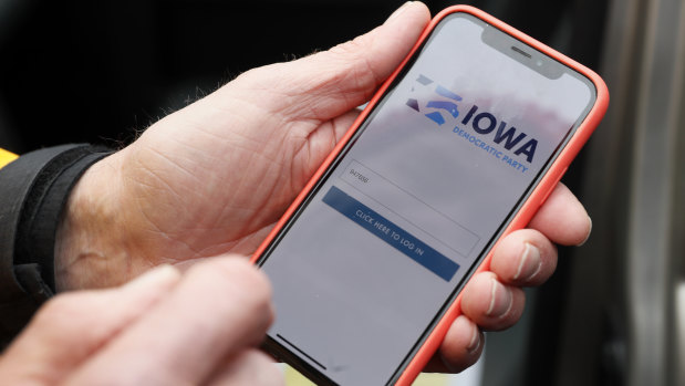 Precinct captain Carl Voss, of Des Moines, Iowa, holds his iPhone that shows the Iowa Democratic Party's caucus reporting app in Des Moines, Iowa. 