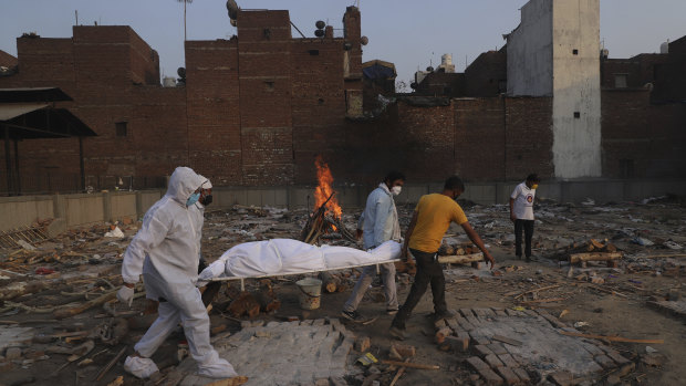 Family members and volunteers carry the body of a COVID-19 victim before cremation in New Delhi in May.