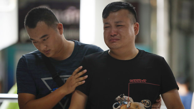 A relative of a victim in the boat sinking being consoled at the Vachira Phuket Hospital.