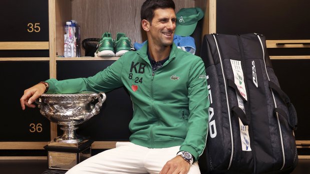 Djokovic with the Norman Brookes Cup in the locker room after his five-set victory over Dominic Thiem.