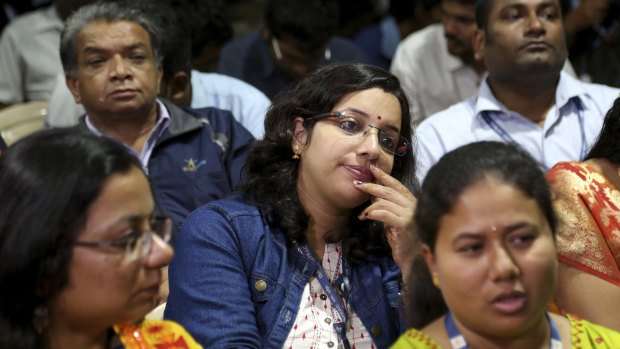 Indian Space Research Organisation (ISRO) employees react after the announcement.