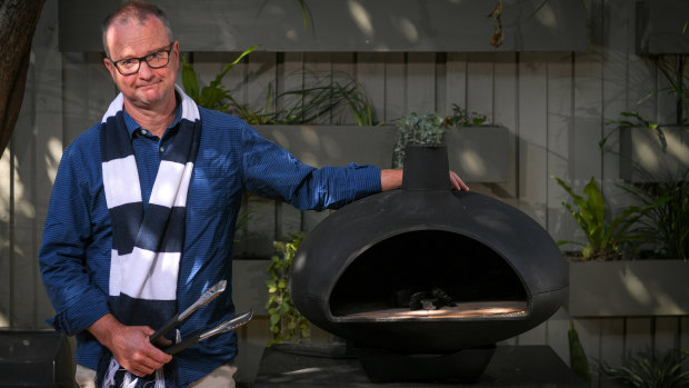 Geelong supporter Richard Armstrong with his new pizza oven.