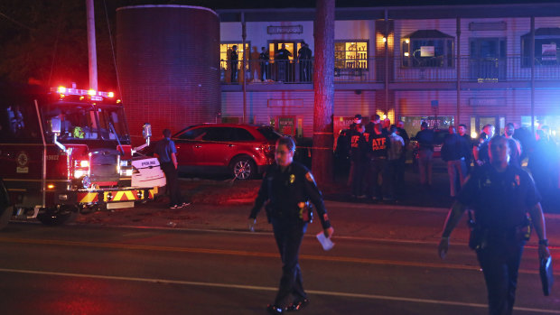 Police investigators work the scene of a shooting on Friday night.