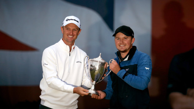 Host Justin Rose presents the trophy to Eddie Pepperell after winning the British Masters