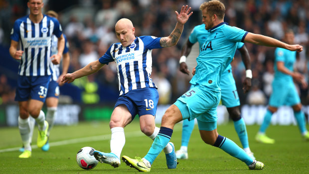 Aaron Mooy of Brighton & Hove Albion shields the ball from Eric Dier of Tottenham Hotspur at American Express Community Stadium.