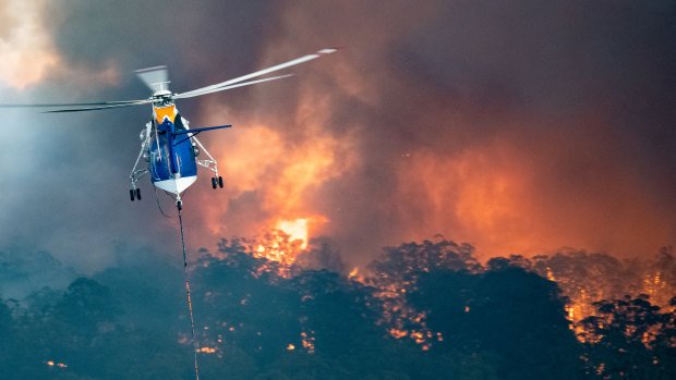 A firefighting helicopter tackling a bushfire near Bairnsdale in East Gippsland. 