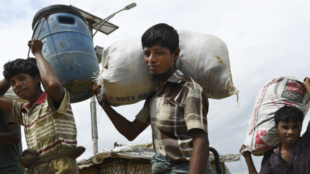 Men carry goods through Kutupalong Camp in Cox's Bazaar, Bangladesh, home to some 900,000 Rohingya refugees.