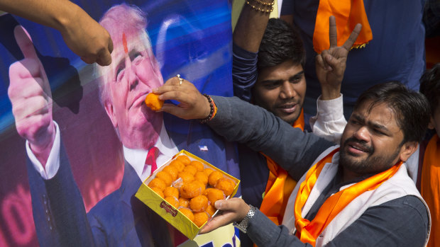 Vishnu Gupta, founder of Hindu Sena, offers sweets to a poster of Donald Trump in 2016.