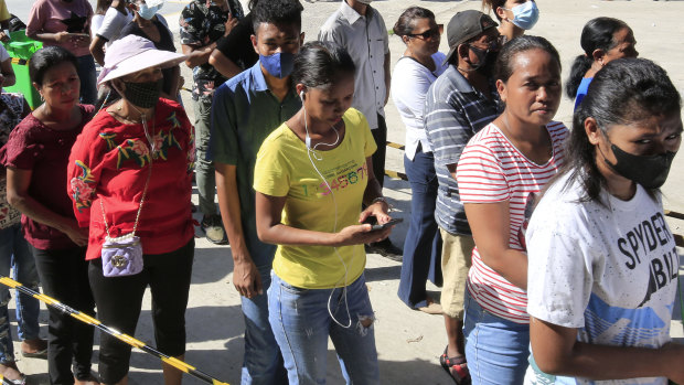 Voters line up to cast their ballots in Dili on Tuesday.